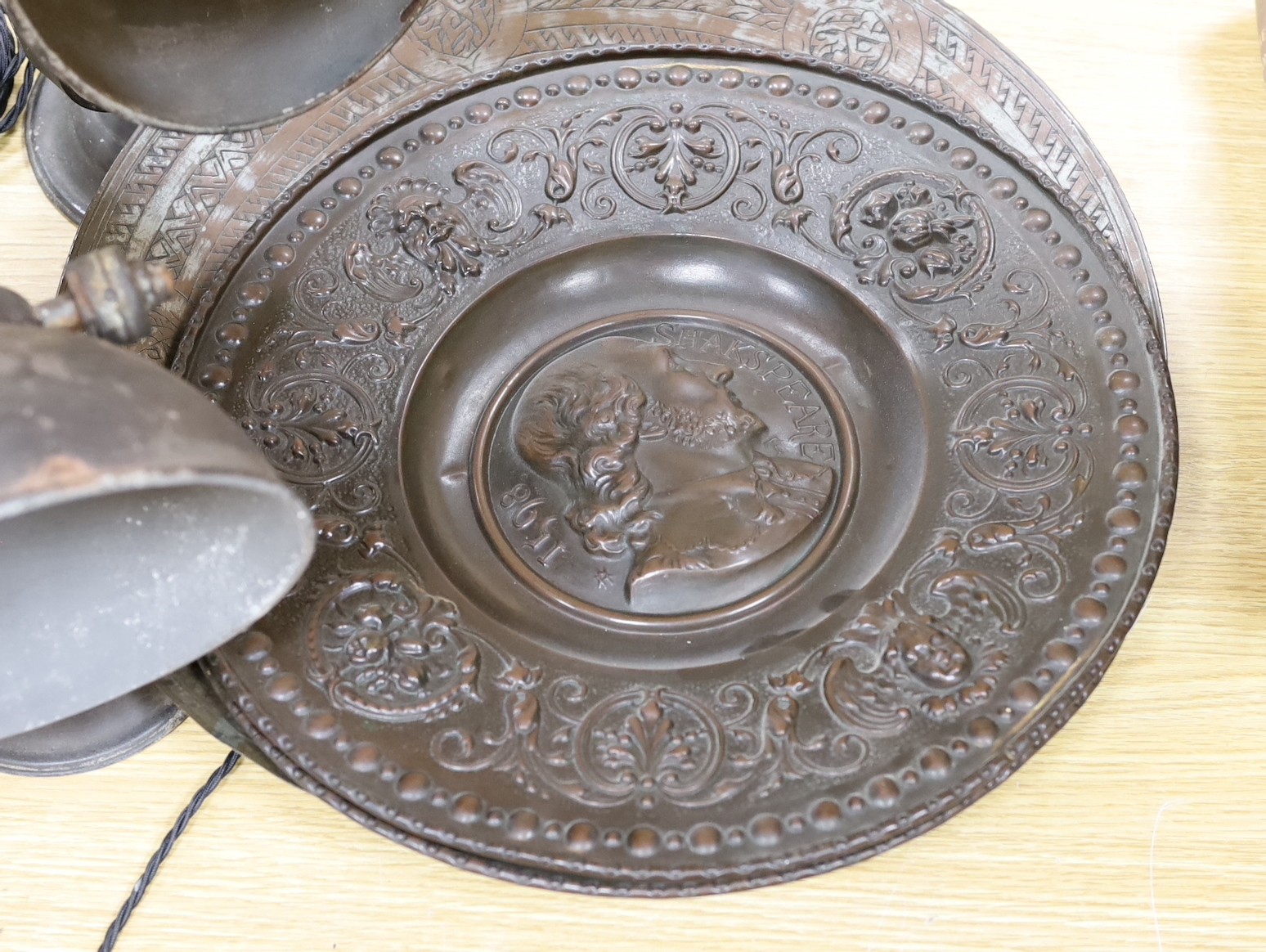 Two pairs of lamps and three metalwork chargers, largest charger 46 cms diameter